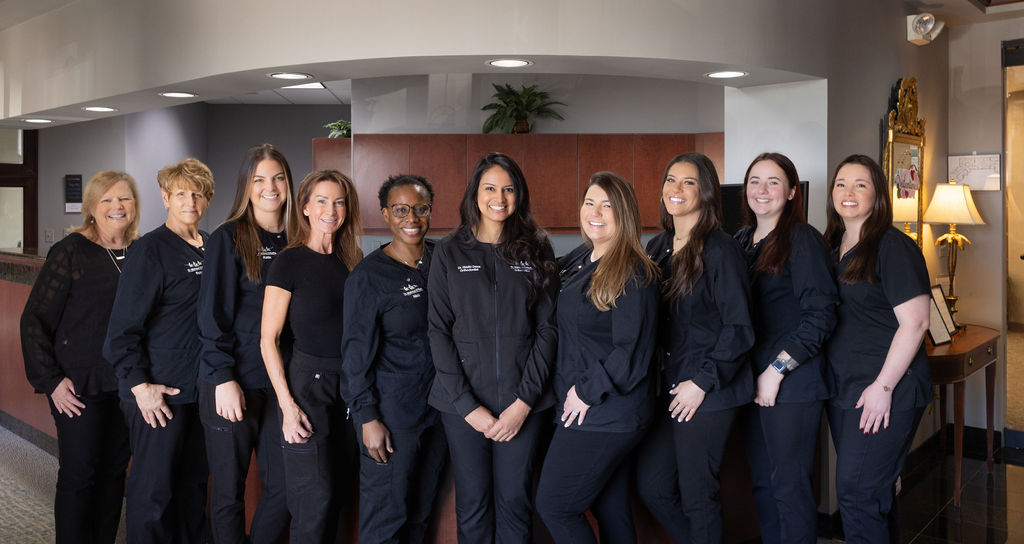 A group image of orthodontist Dr. Riddhi Desai with her team at Family Orthodontics of Annapolis